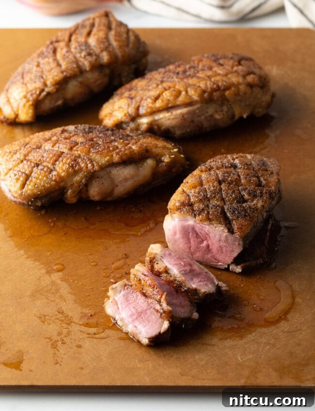 chef slicing pan-seared duck breast