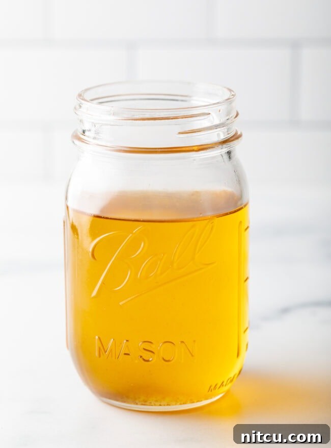 reserved duck fat stored in a glass jar