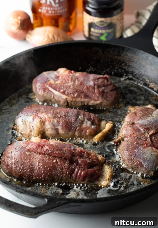 duck breast searing fat side down in a pan