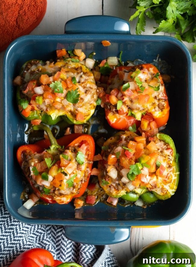 Savory Keto Bell Pepper Boats 3 low carb stuffed peppers recipe in baking dish - overhead view