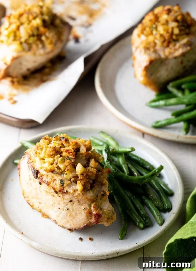 Tender Apple-Stuffed Baked Pork Chops 10 Side view of how to plate the stuffed pork with a side of green beans with it