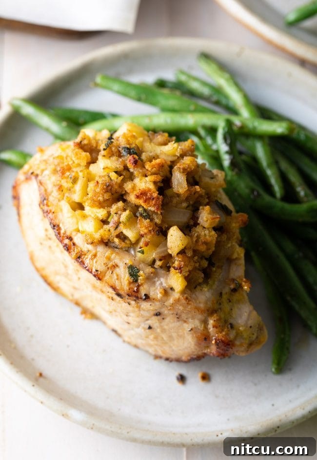Tender Apple-Stuffed Baked Pork Chops 11 Side view of how to plate the stuffed pork chops with a side of green beans with it