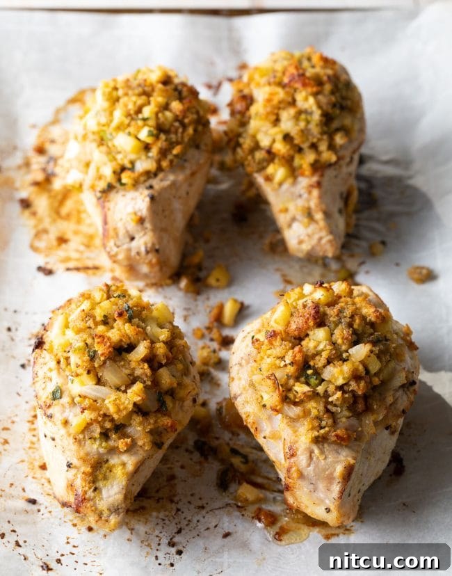 Tender Apple-Stuffed Baked Pork Chops 3 4 pieces of this stuffed pork recipe on a baking sheet lined with parchment paper