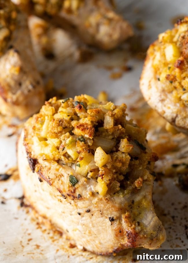Tender Apple-Stuffed Baked Pork Chops 9 Baking sheet with the stuffed pork from the side to show the juicy filling