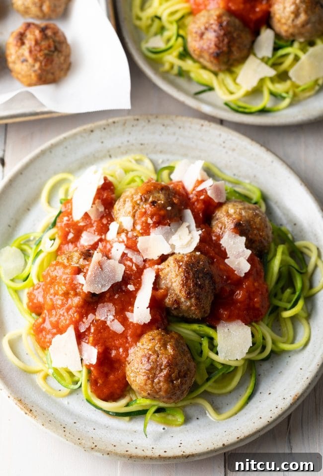 healthy baked turkey meatballs on a plate with zucchini noodles