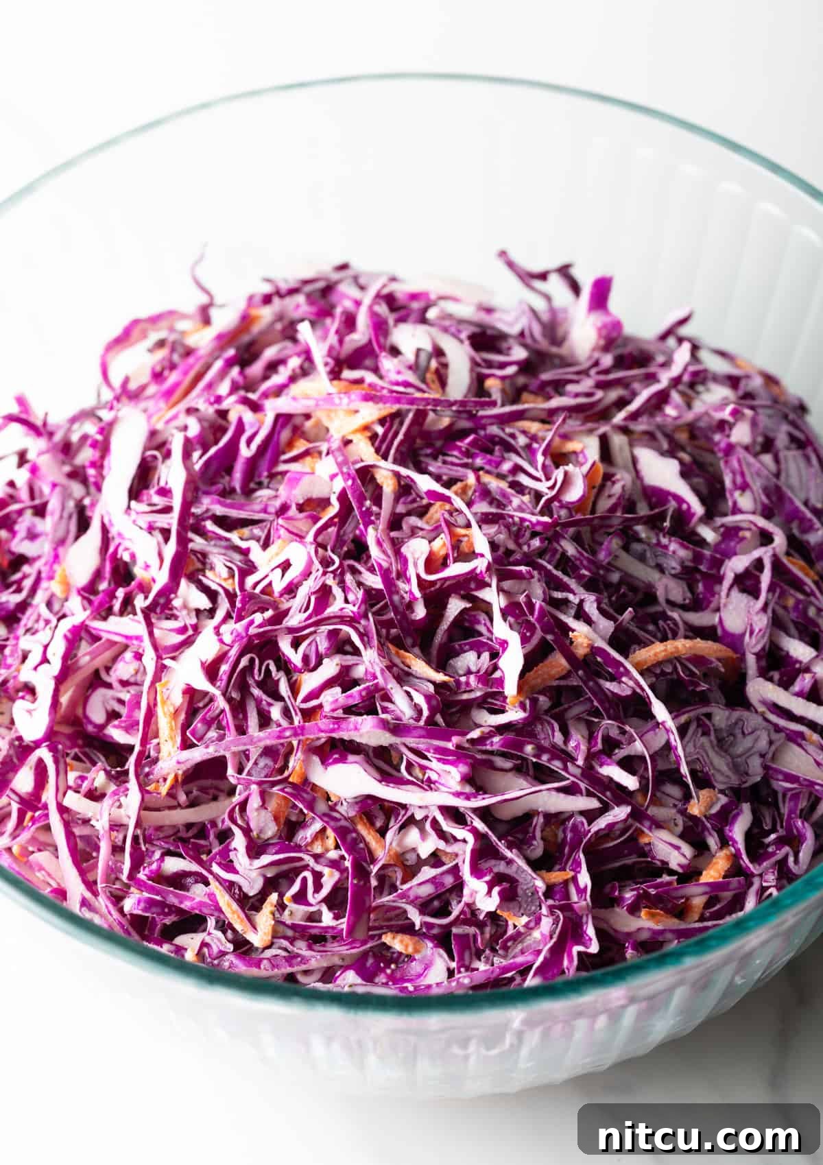 Crimson Cabbage Crunch 3 Overhead shot of a red cabbage slaw recipe in a glass bowl.
