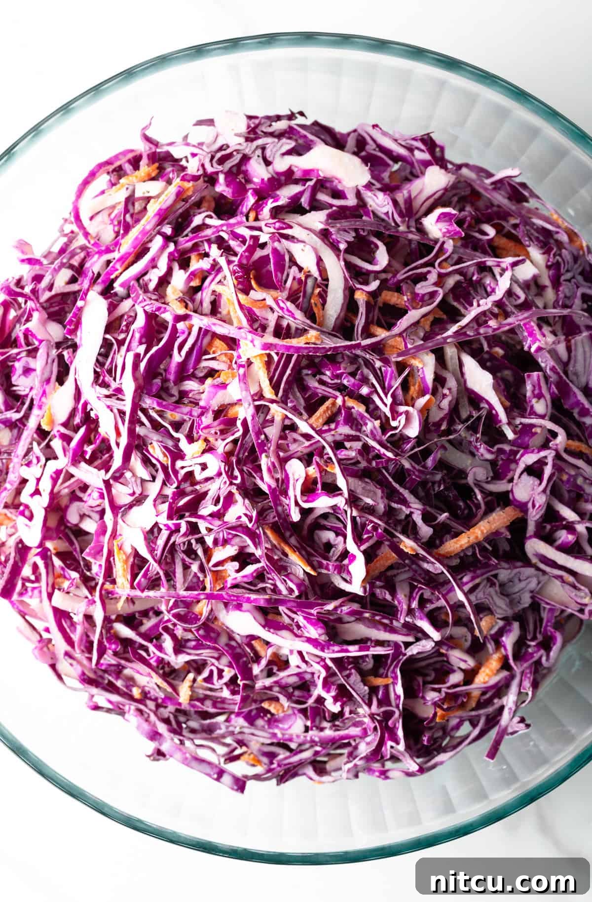 Crimson Cabbage Crunch 9 Overhead shot of a red cabbage slaw recipe in a glass bowl.