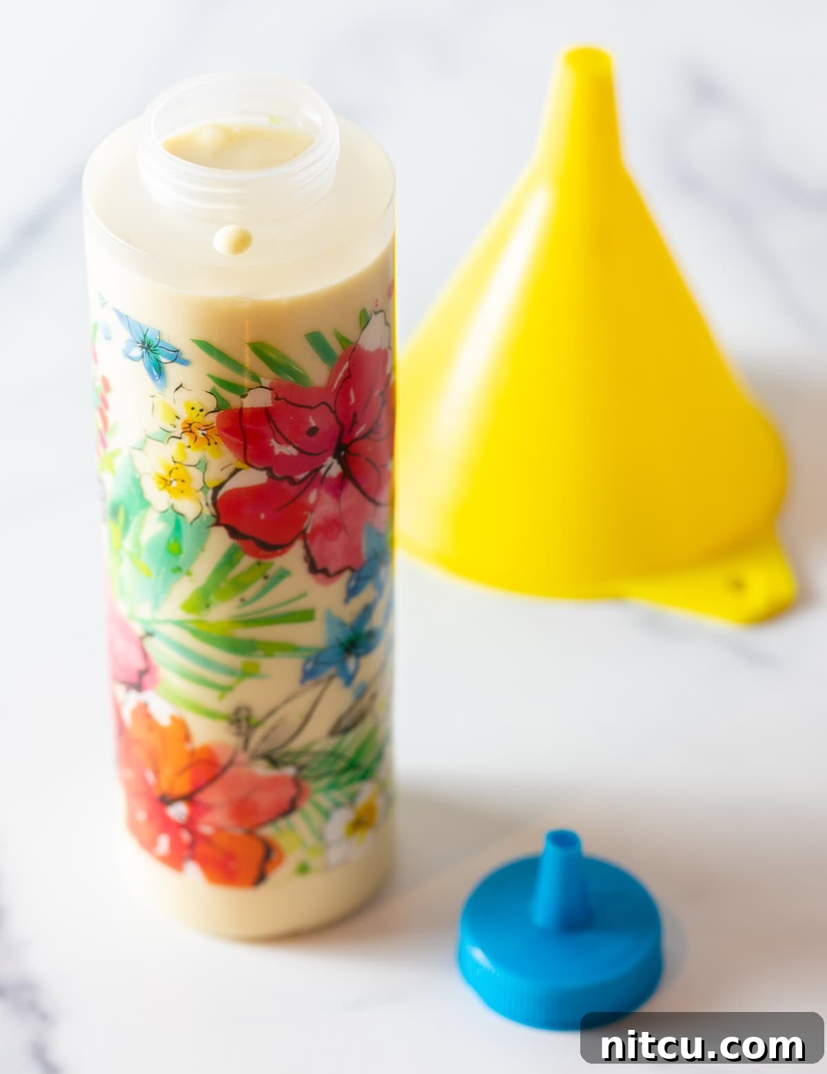 Funnel cake batter is in a plastic squirt bottle for easy pouring.