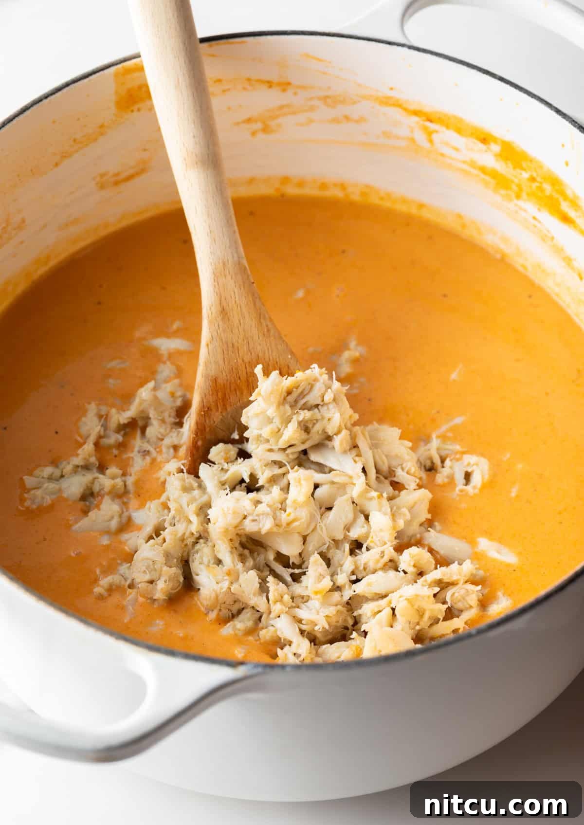 Decadent Crab Bisque 10 Crab meat is being added to a crab bisque soup recipe.