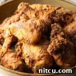 Crispy homemade southern fried chicken pieces in a bowl.